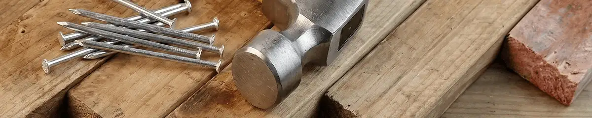 Hammer and nails on hardwood flooring boards in Columbia, SC
